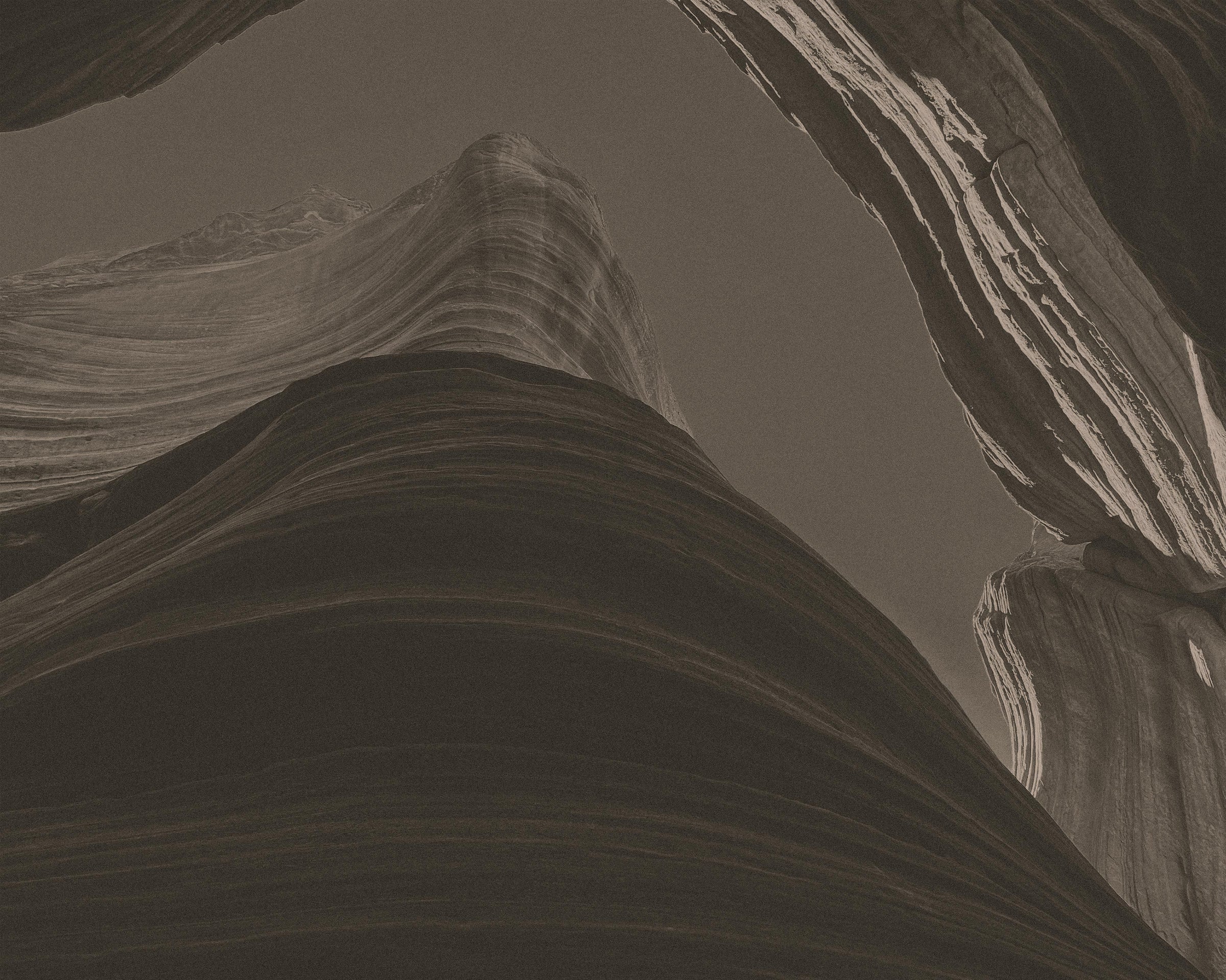 Close-up black and white photograph of a canyon wall and rock formation