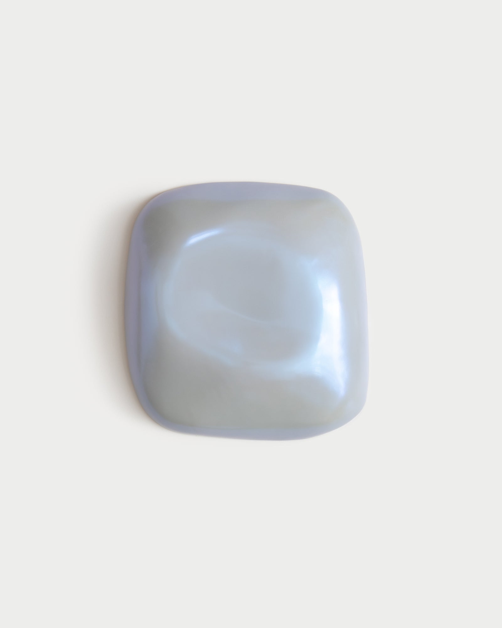 Small pale blue ceramic fragment on a white background