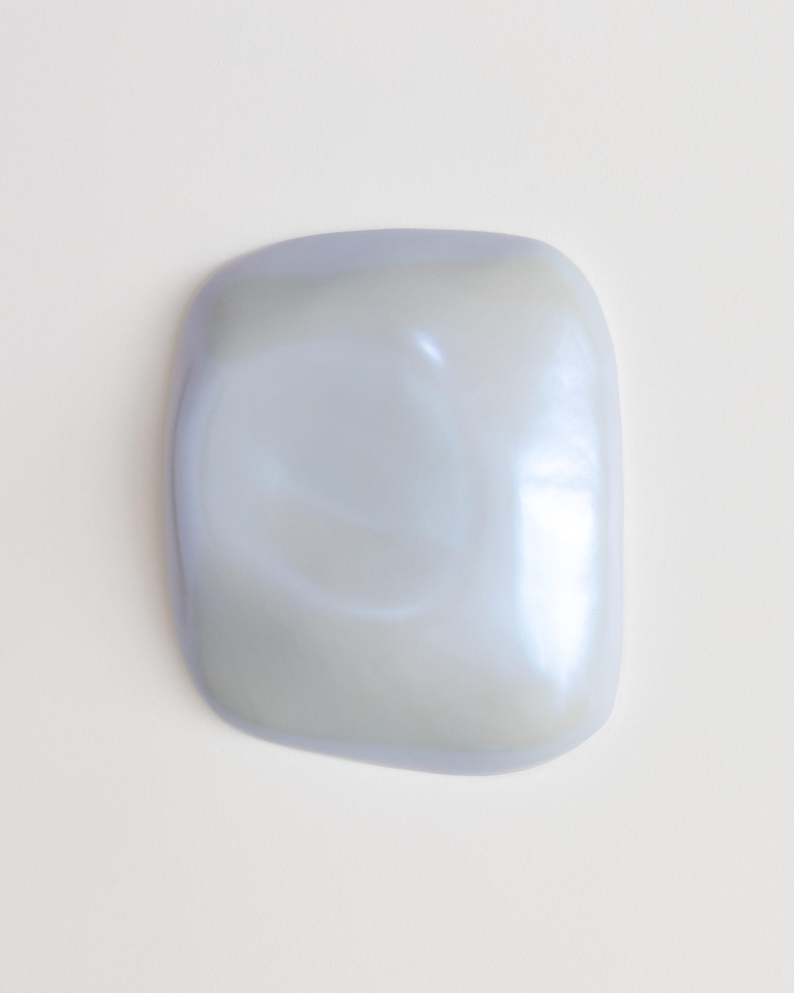 Pale blue ceramic fragment on a white background