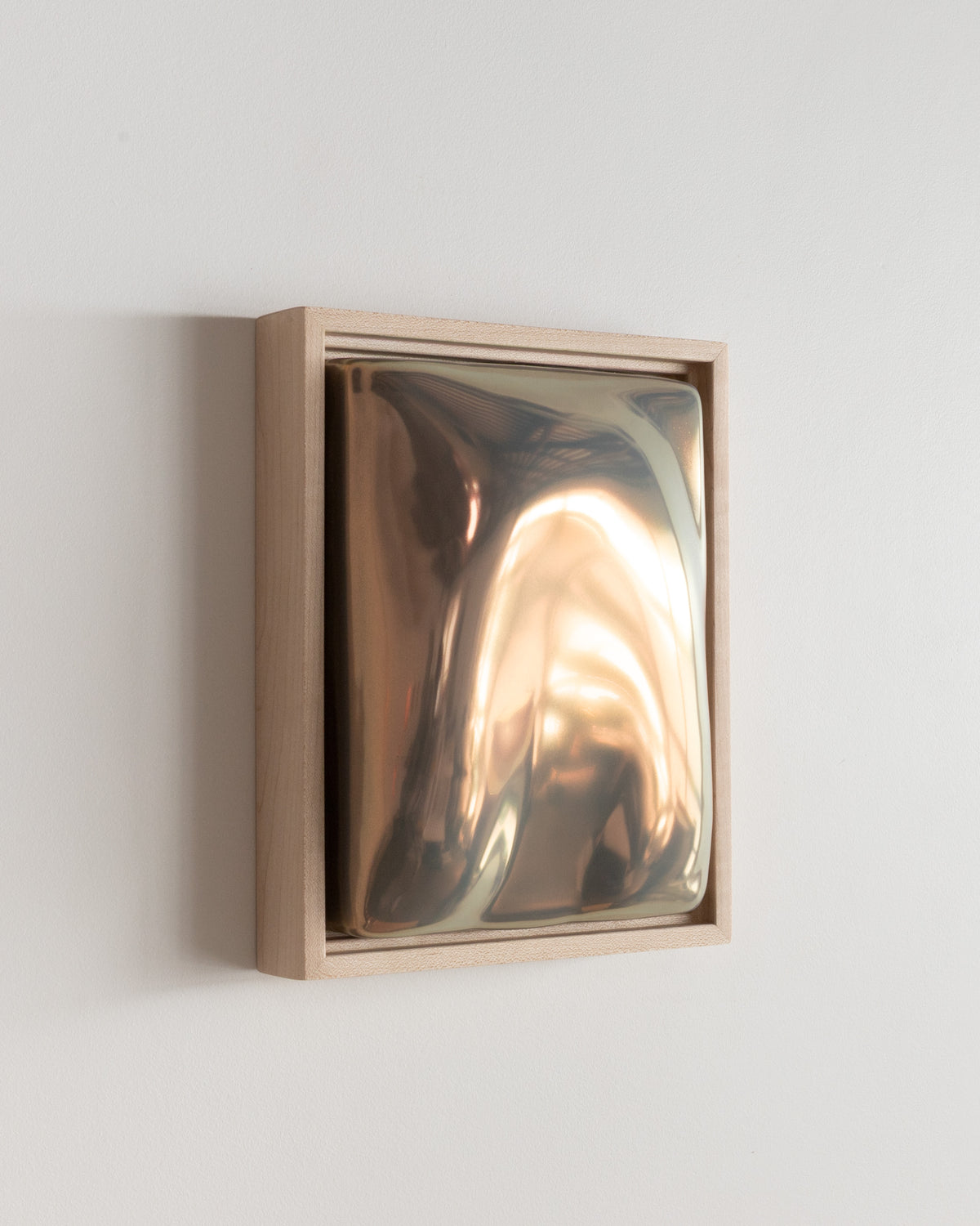 Angled detail of "Arch" showing the framed ceramic wall relief and iridescent glaze