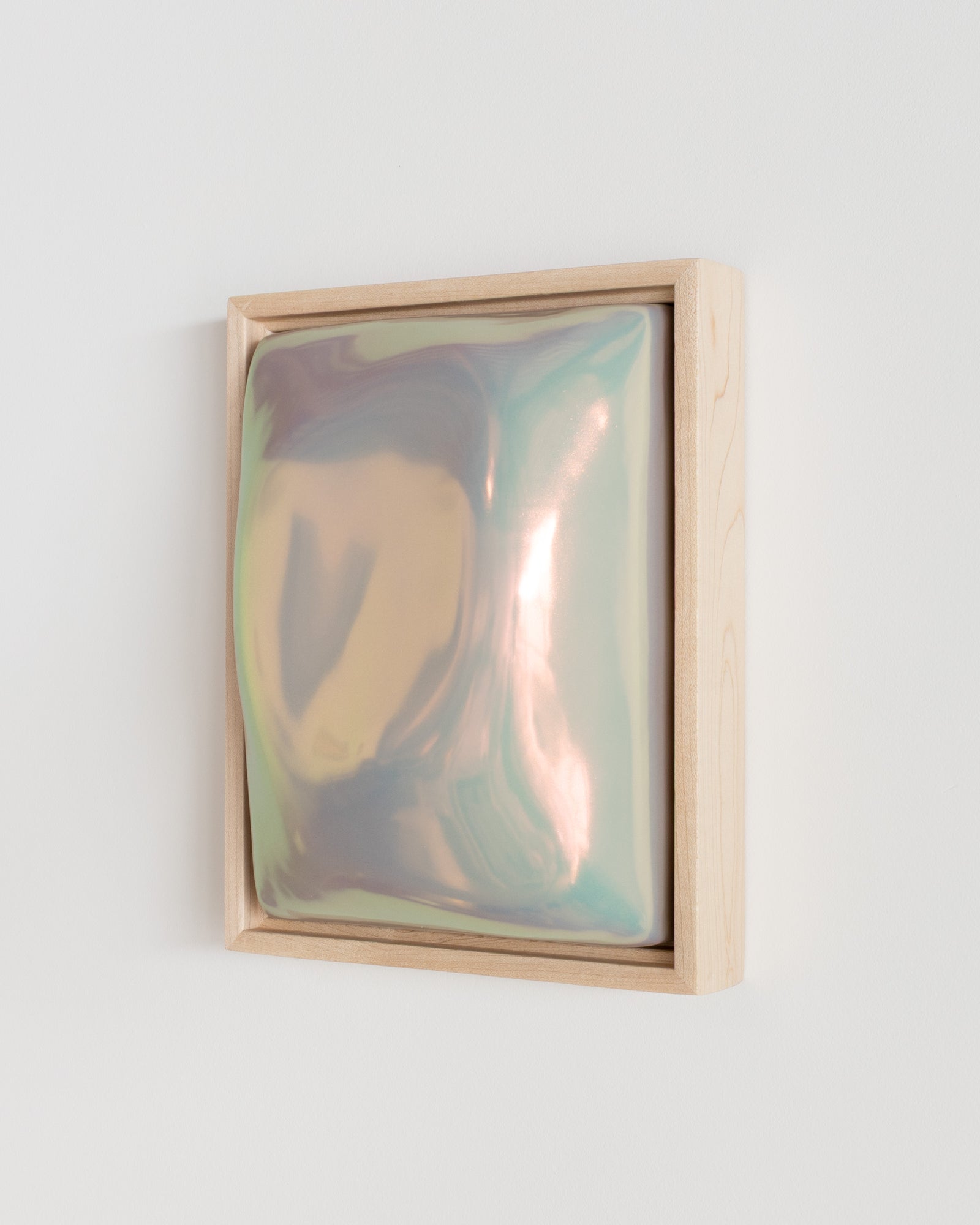 Side detail of Fold showing the framed ceramic wall relief and soft taupe iridescent glaze