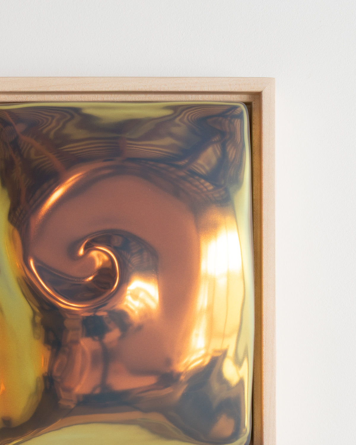 Close-up detail of "Nautilus" showing the raised spiral form and reflective iridescent glaze