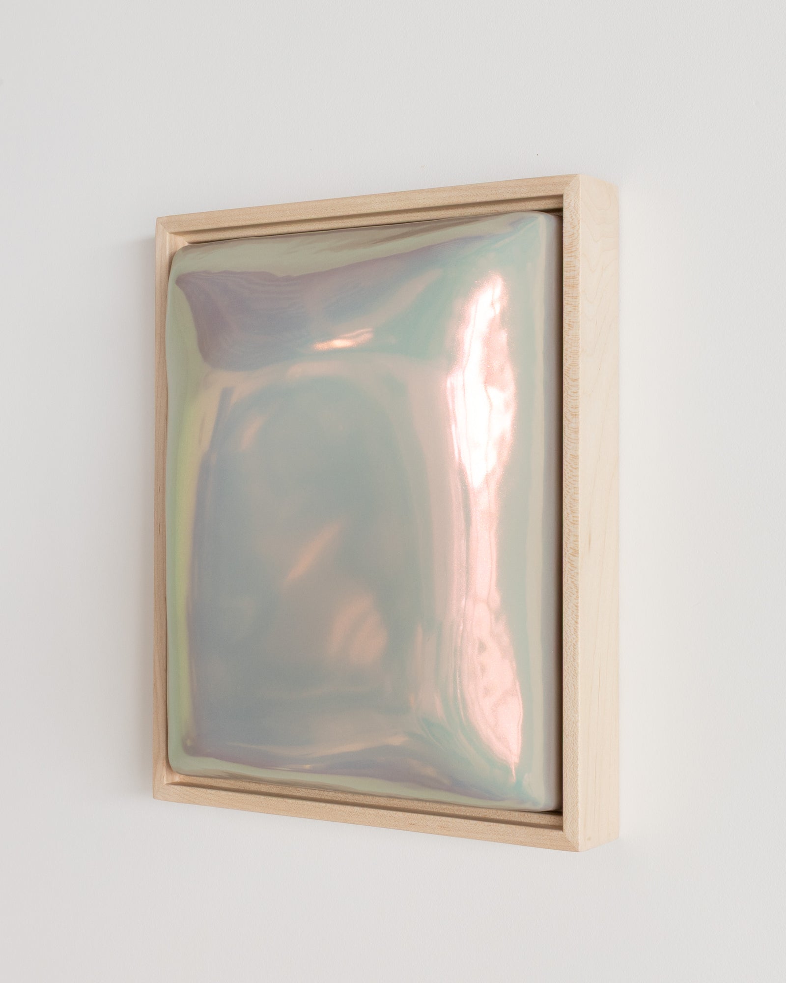 Side detail of Trace showing the framed ceramic wall relief and soft taupe iridescent glaze