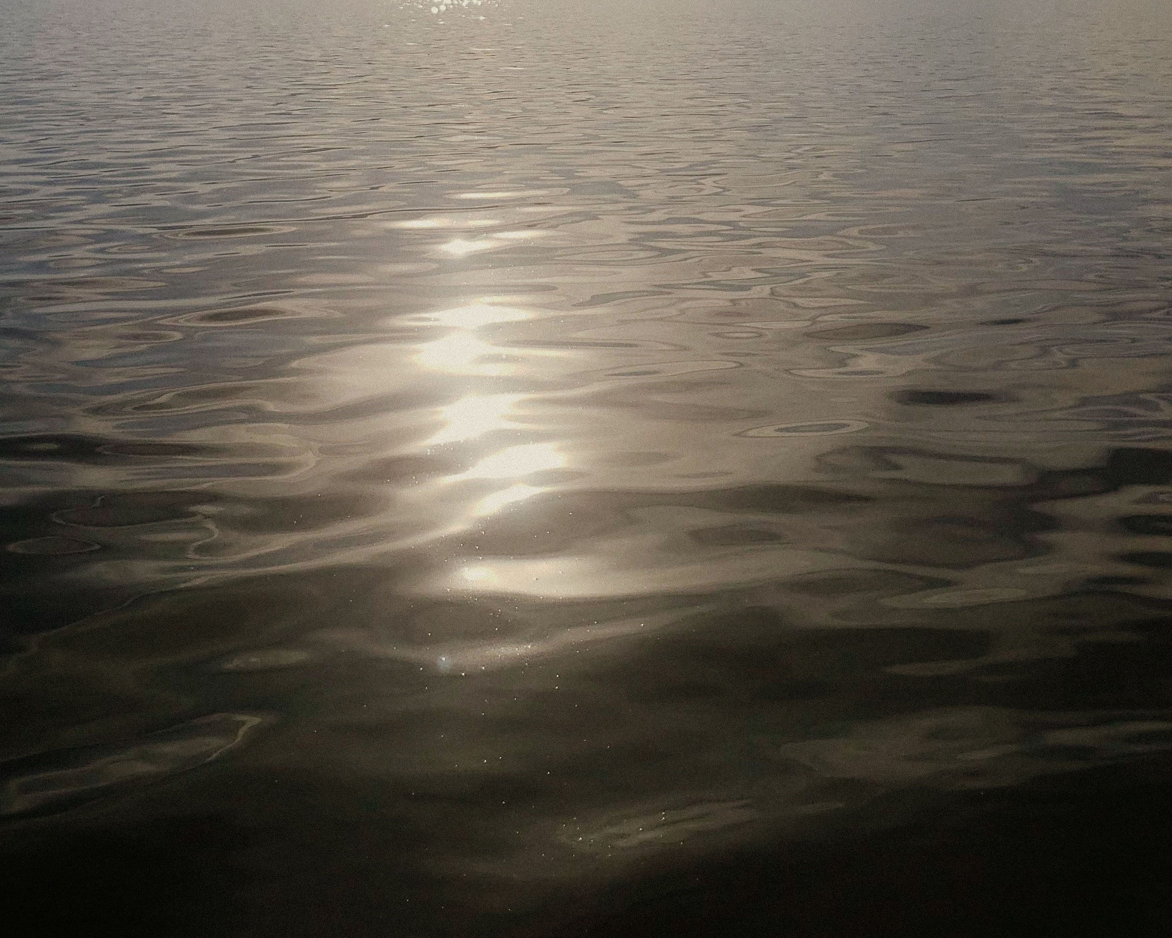 Rippled water surface with sunlight reflection
