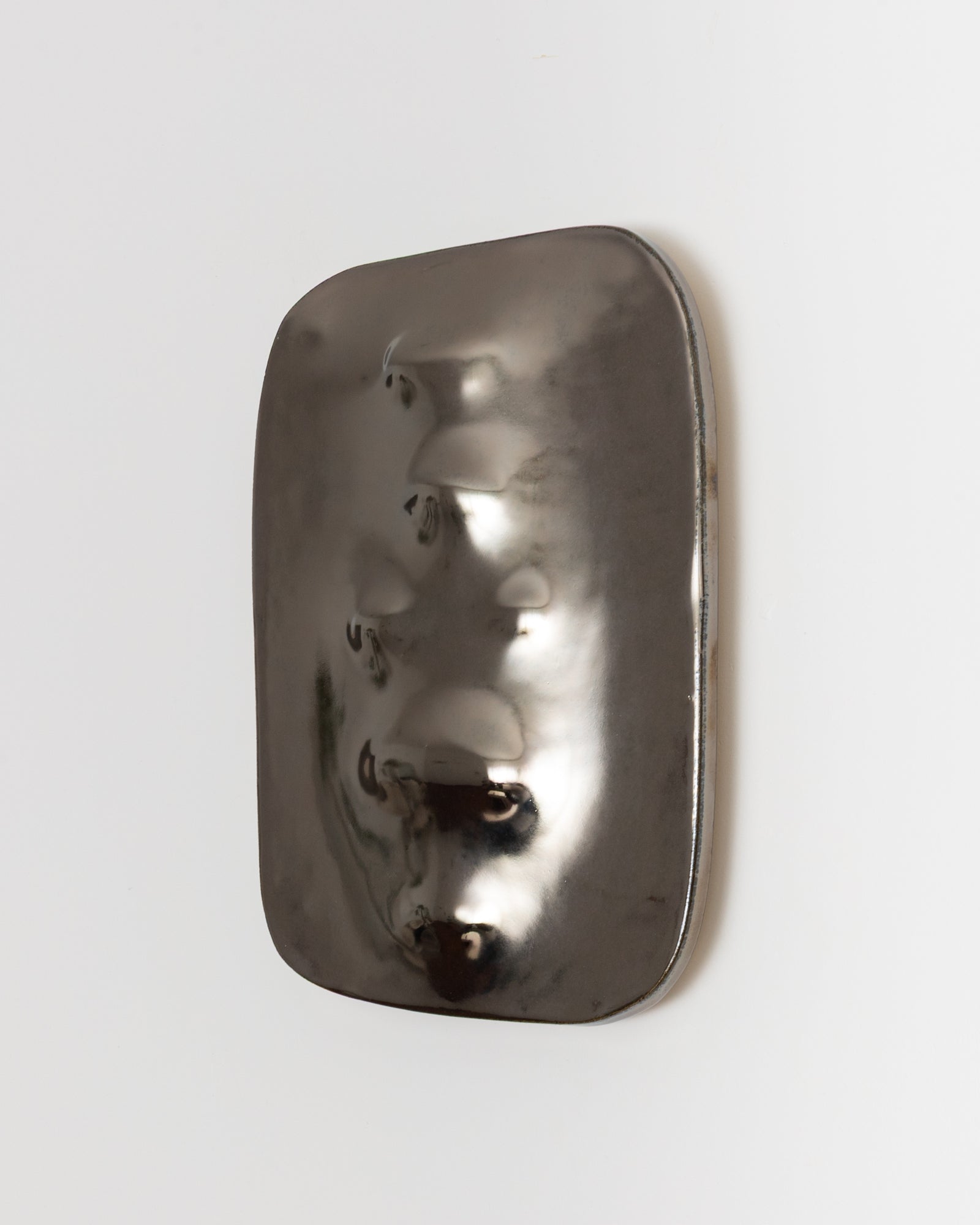 Side detail of Symbols 04 showing the framed ceramic artwork and iridescent surface