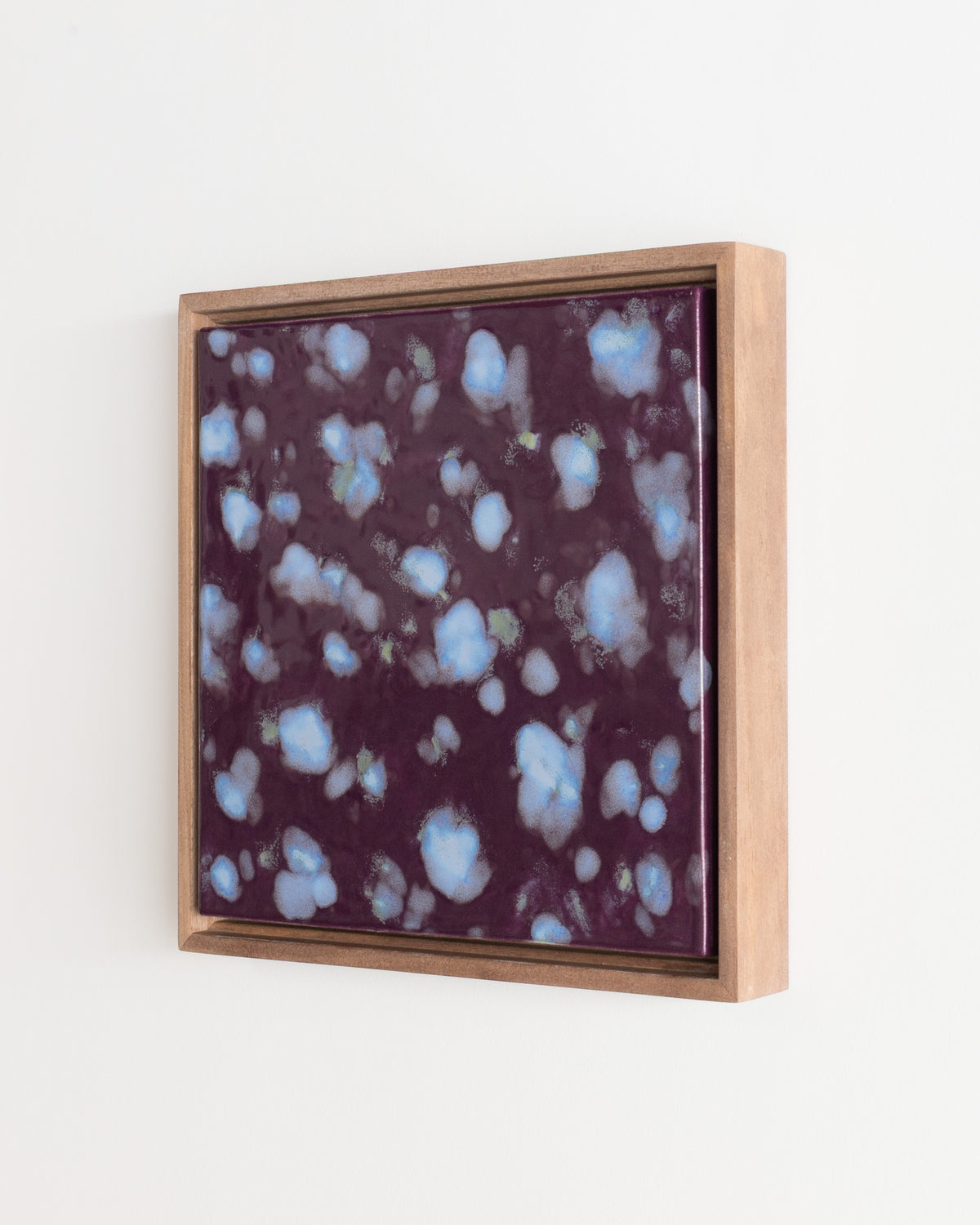 Detail of "Snow on Petals" showing pale blue petal forms on deep burgundy