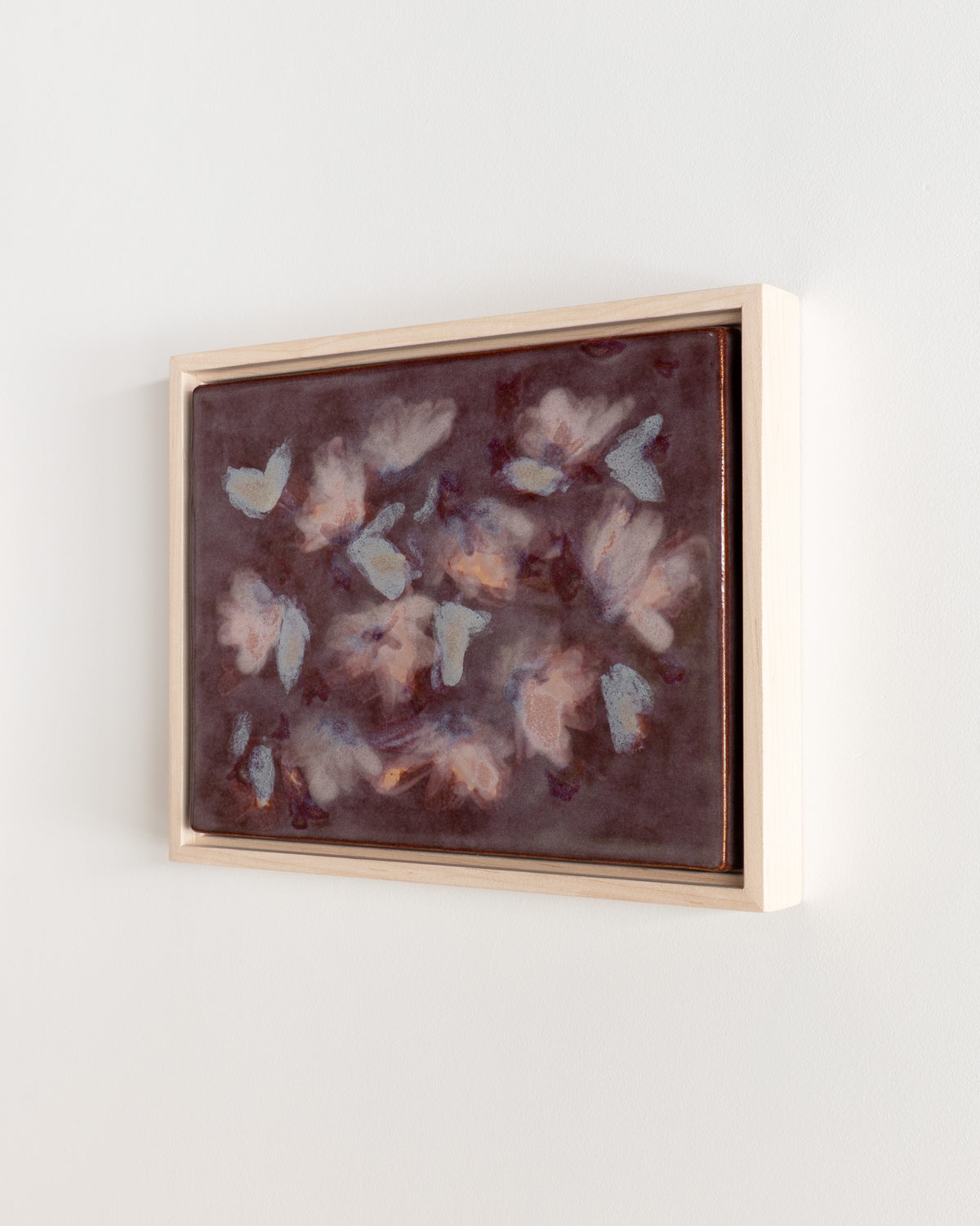 Detail of "Flutter" showing pale blue and pink petal forms across a burgundy surface