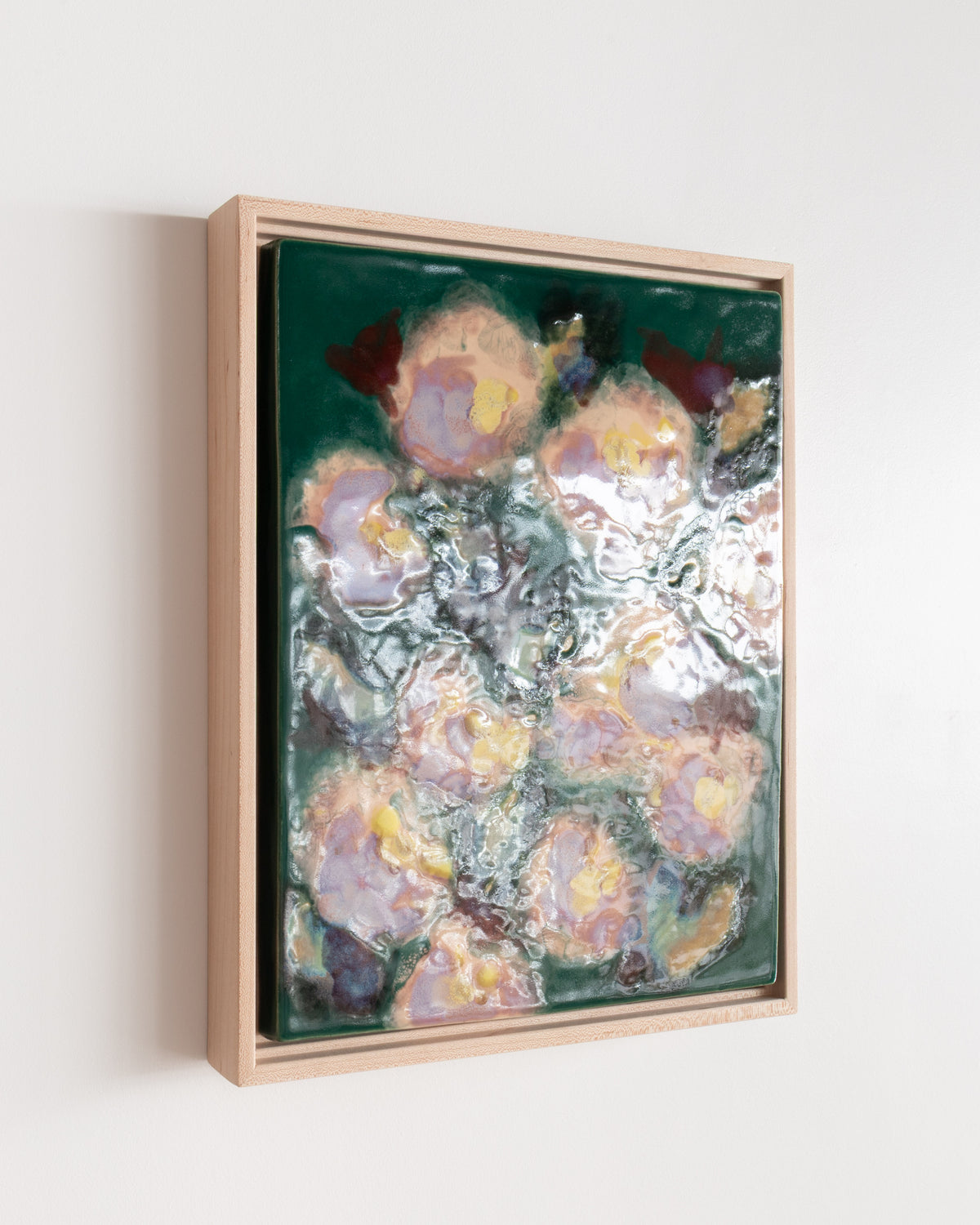 Angled detail of "I'll Be in the Garden" showing glossy pale flowers on deep green
