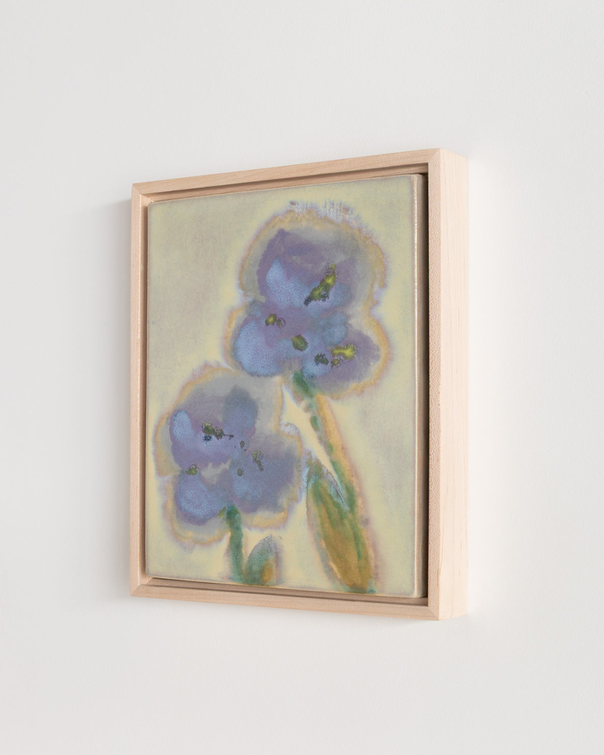 Detail of "A Leaning" showing blue flowers, green stems, and a glossy pale green surface