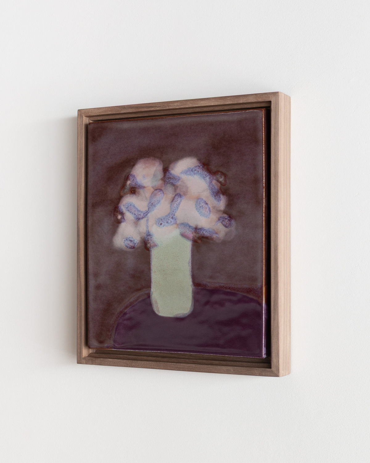 Detail of "A Taller Vase" showing pale flowers in a green vase on a burgundy background