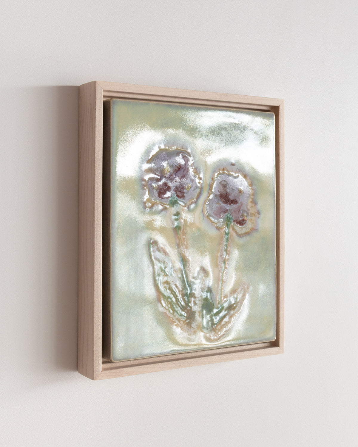 Angled detail of "Between You and Me" showing glossy glaze over two burgundy flowers