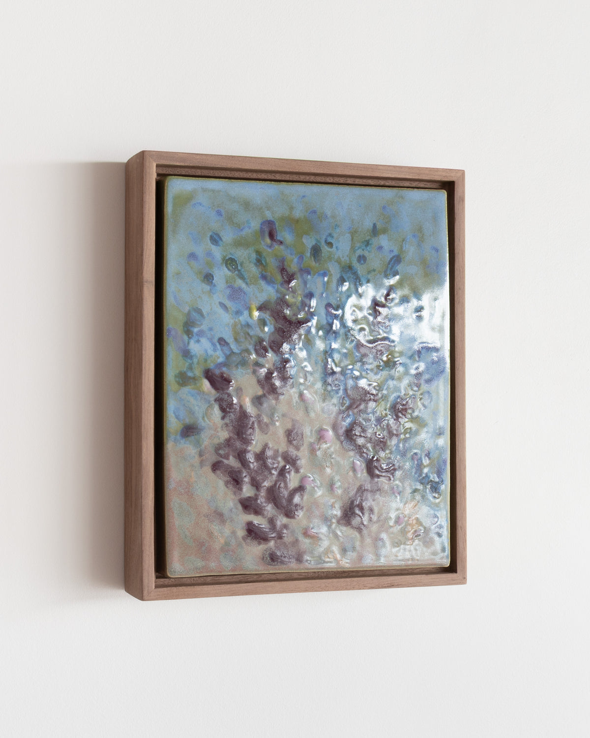 Angled detail of "Wildflowers" showing glossy blue and burgundy floral marks