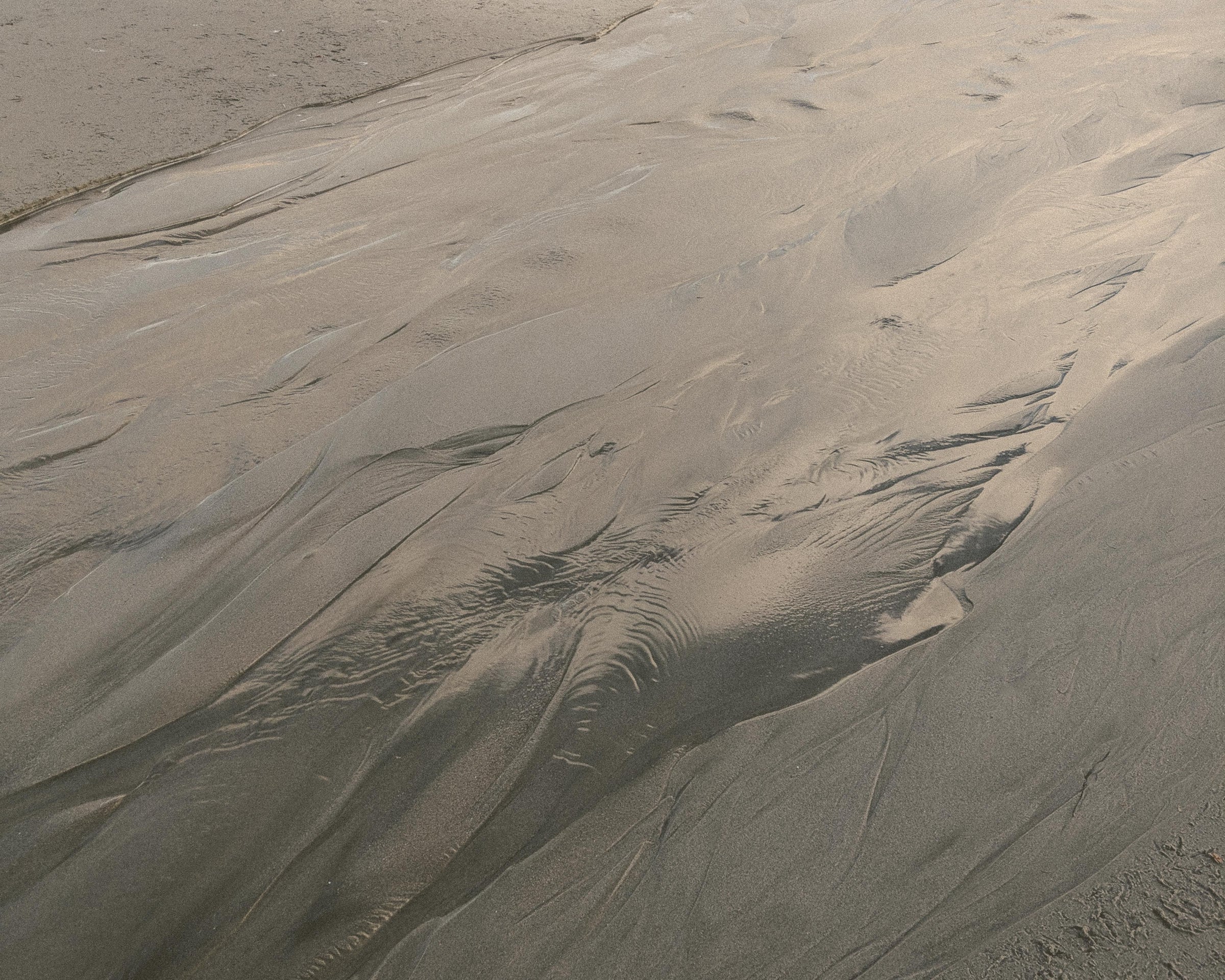Textured sand dune with patterns and shadows