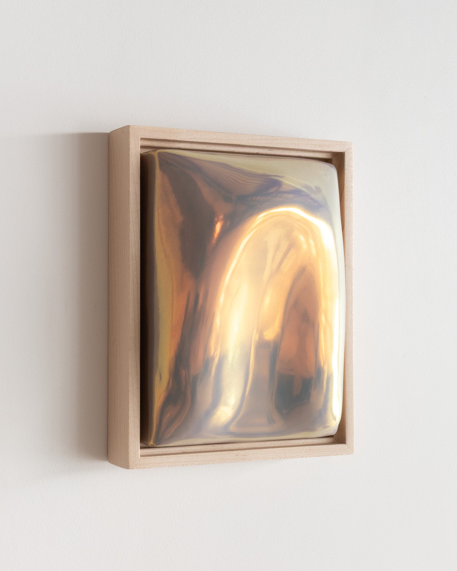 Angled detail of Arch showing the framed ceramic wall relief and iridescent glaze
