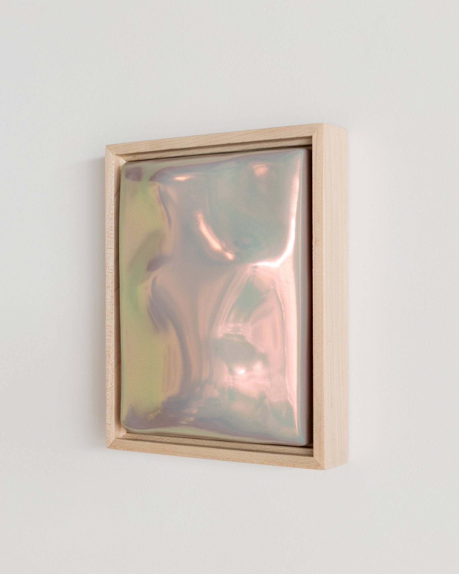 Side detail of Archive showing the framed ceramic wall relief and lilac iridescent glaze