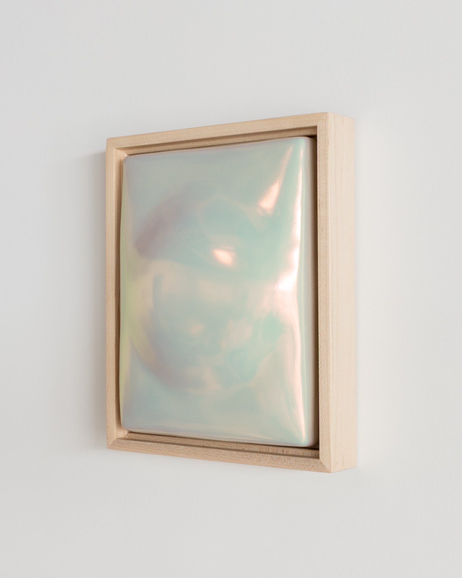 Side detail of Dome Dusk showing the framed ceramic wall relief and light iridescent glaze