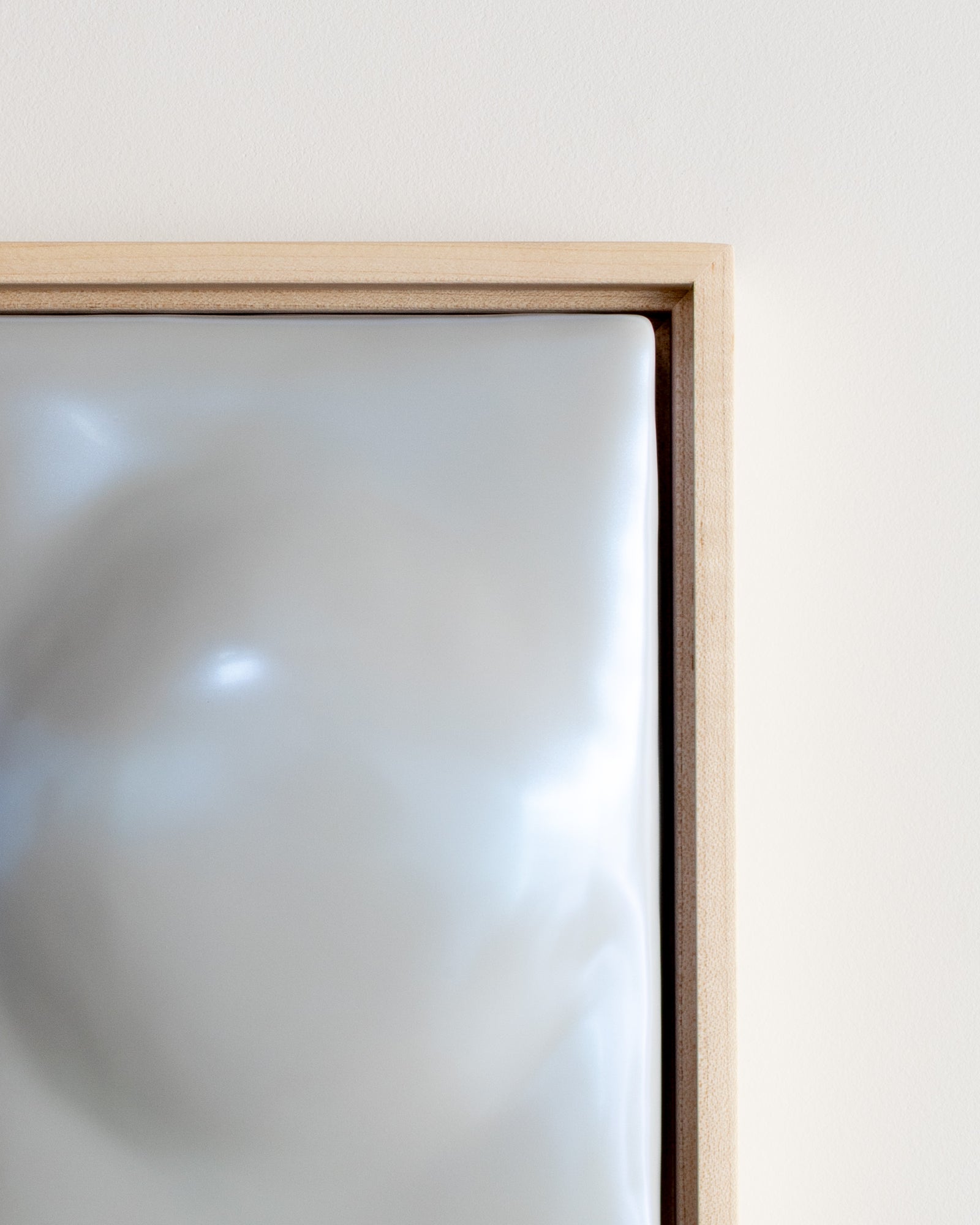 Close-up of a pale blue framed ceramic relief surface