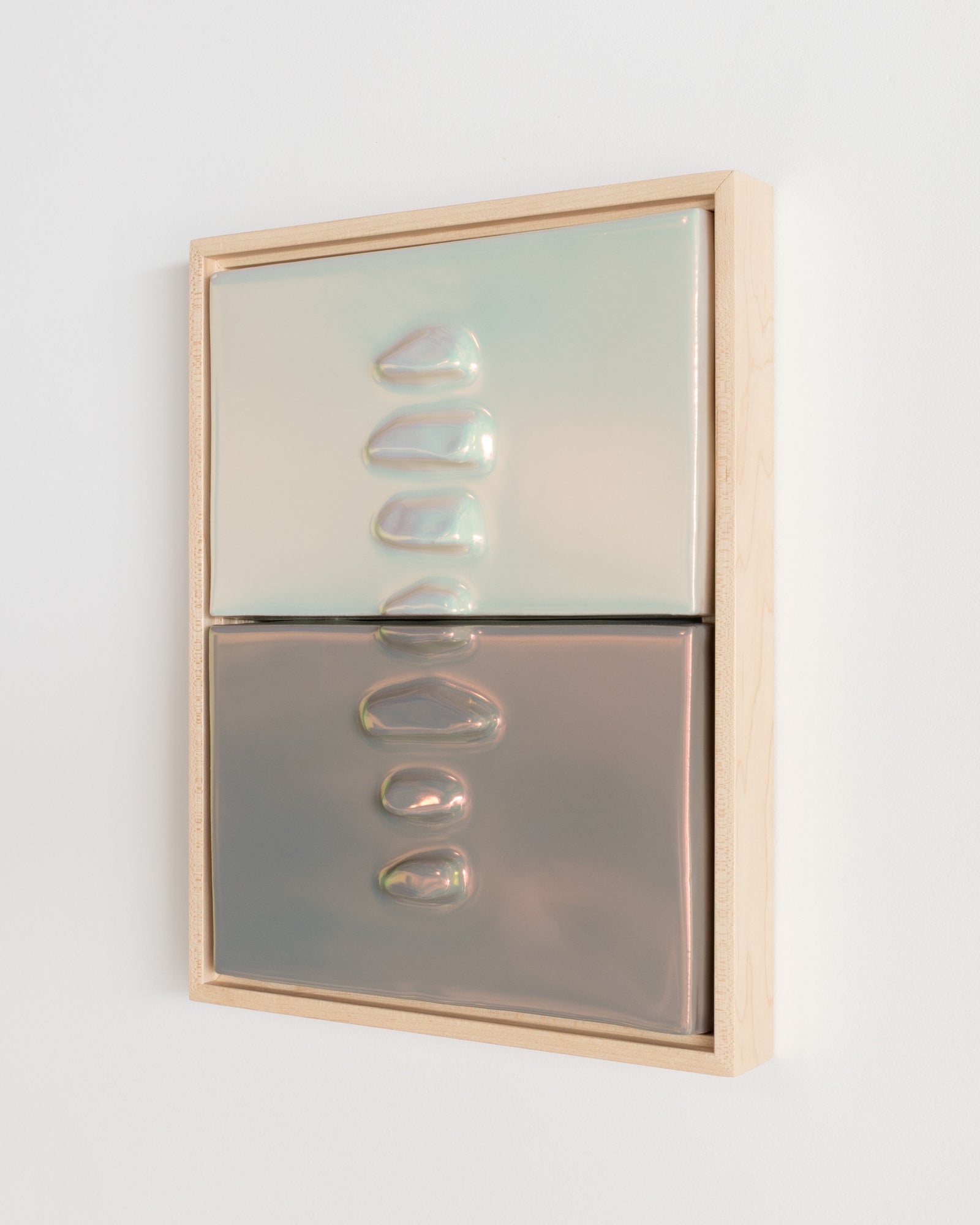 Side detail of Duo Formations showing the framed ceramic wall relief and light taupe iridescent glaze