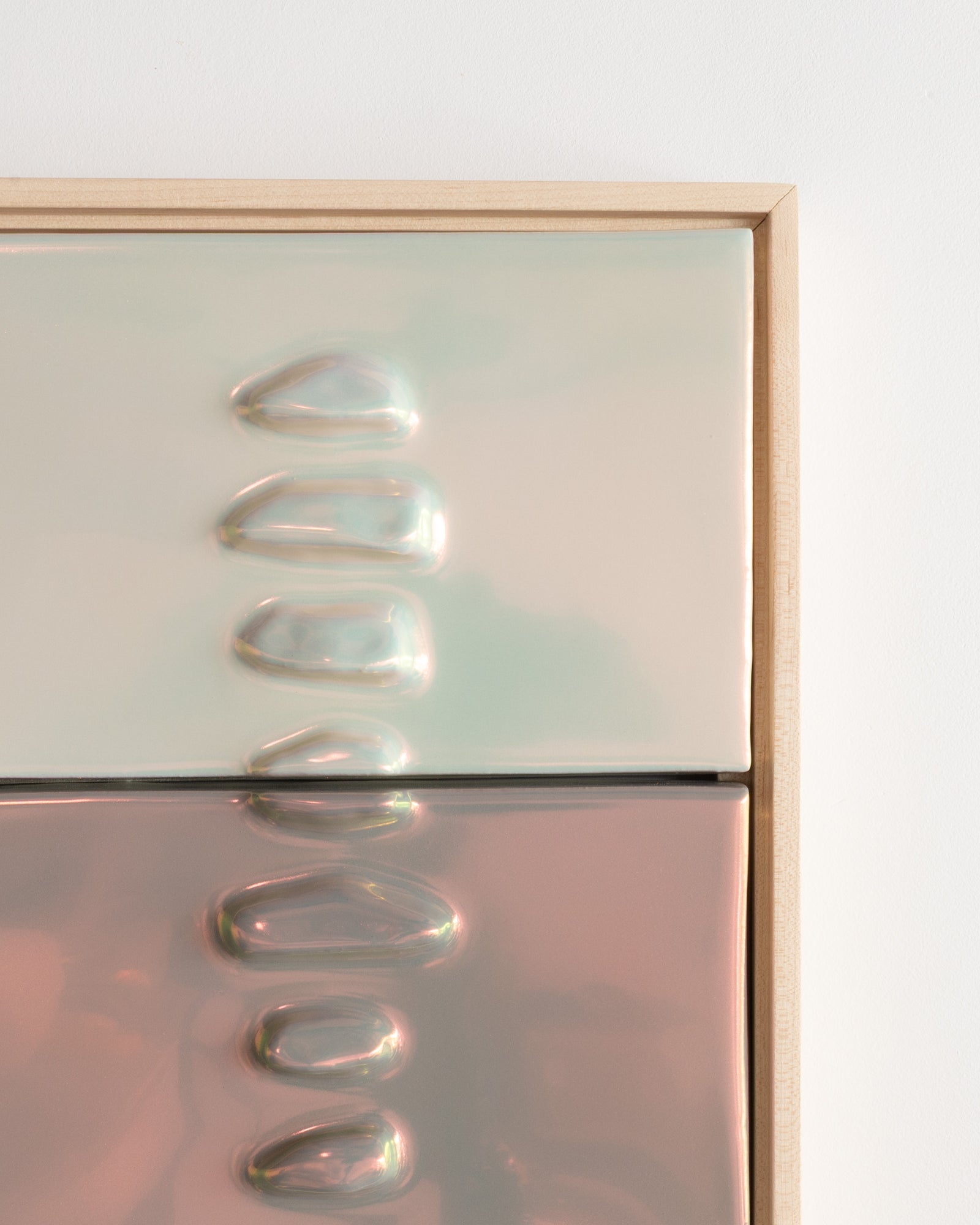 Angled detail of Duo Formations showing the two-panel raised formation and light taupe iridescent glaze