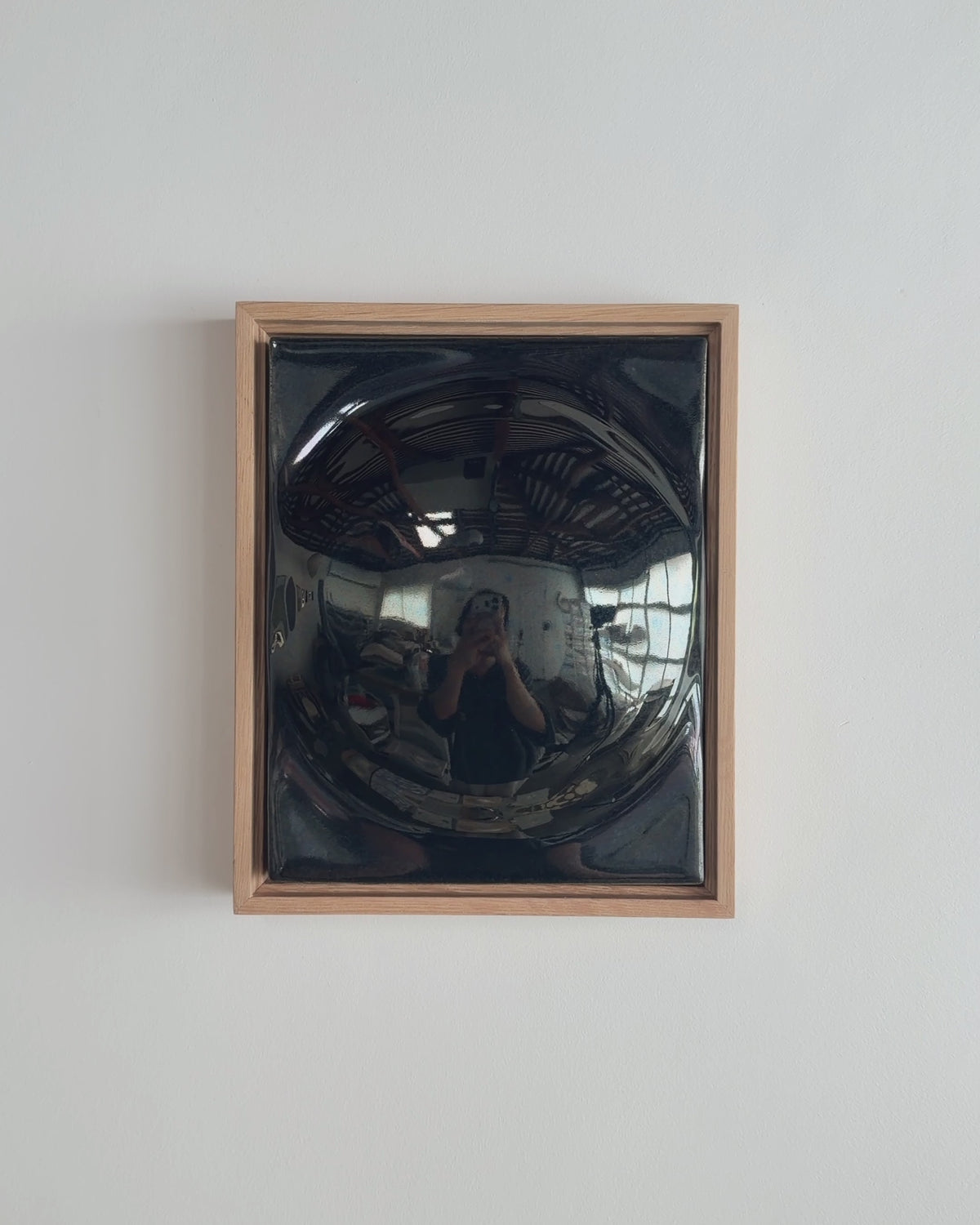 Video thumbnail of a black framed ceramic wall relief with a rounded form