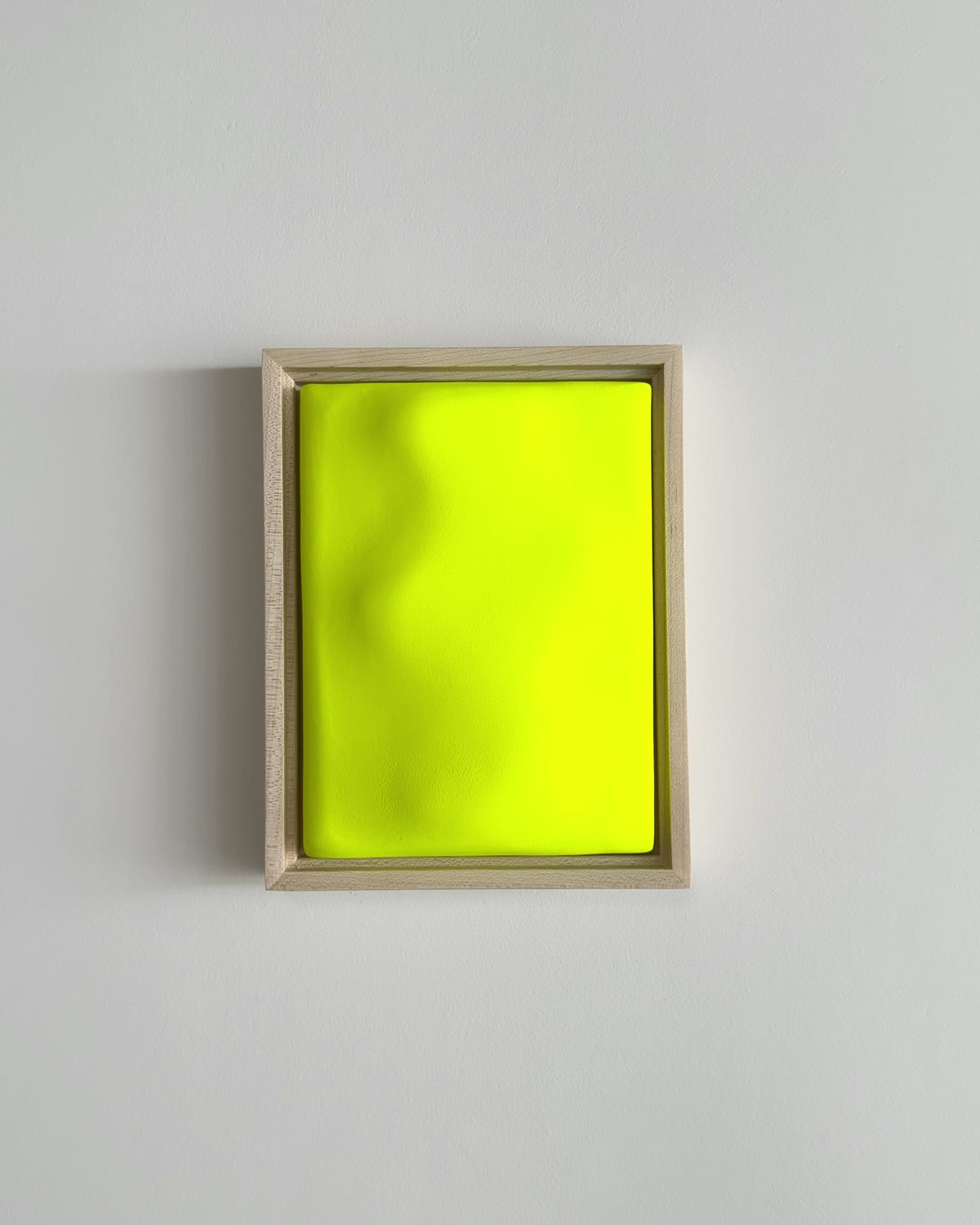 Video thumbnail of a fluorescent yellow framed ceramic wall relief