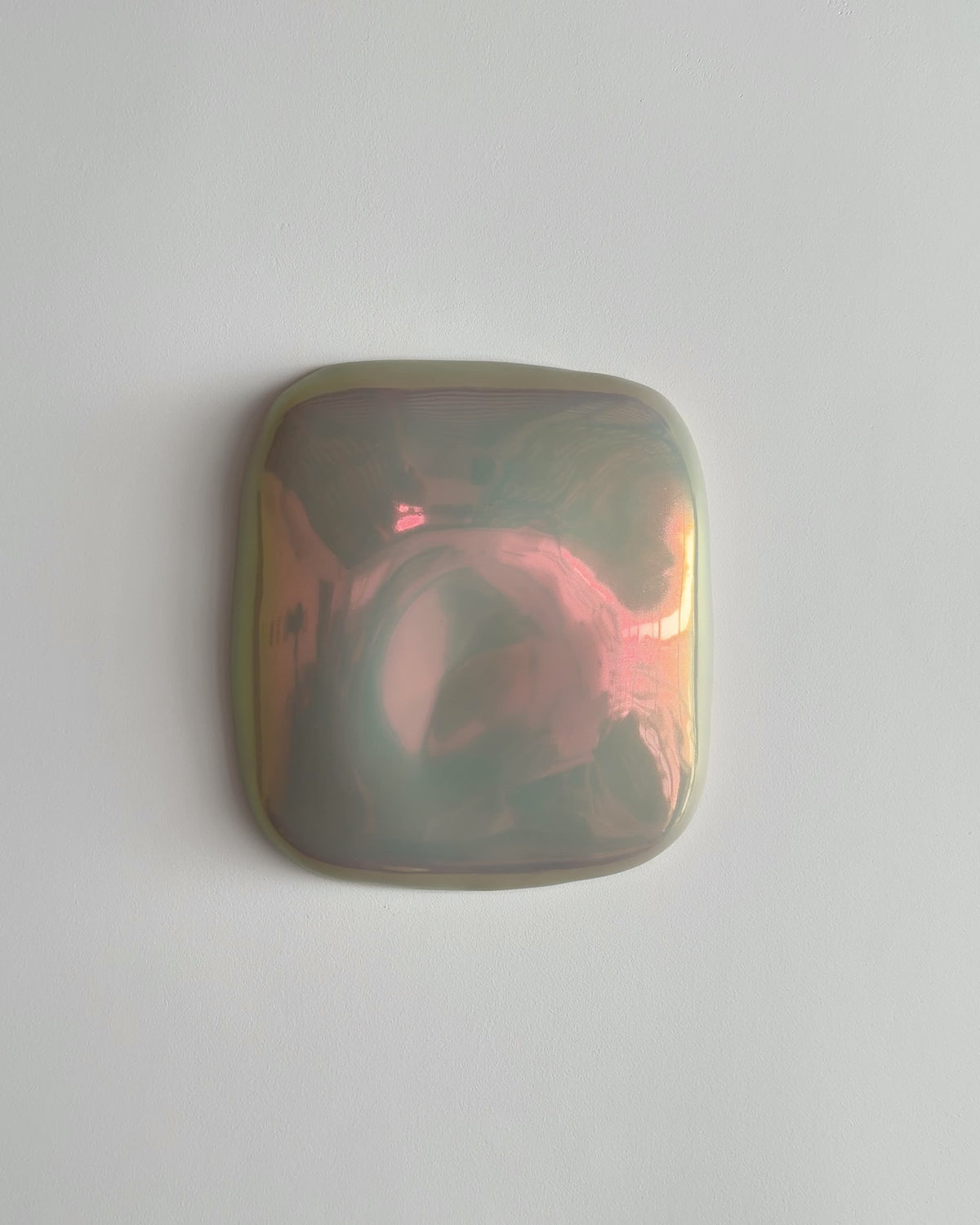 Video thumbnail of a small iridescent ceramic fragment on a white background