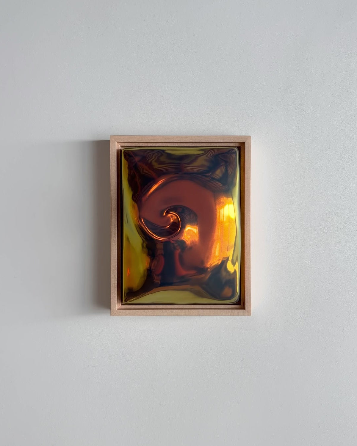 Video of "Nautilus" 6x8" ceramic wall relief showing a raised spiral form and iridescent glaze