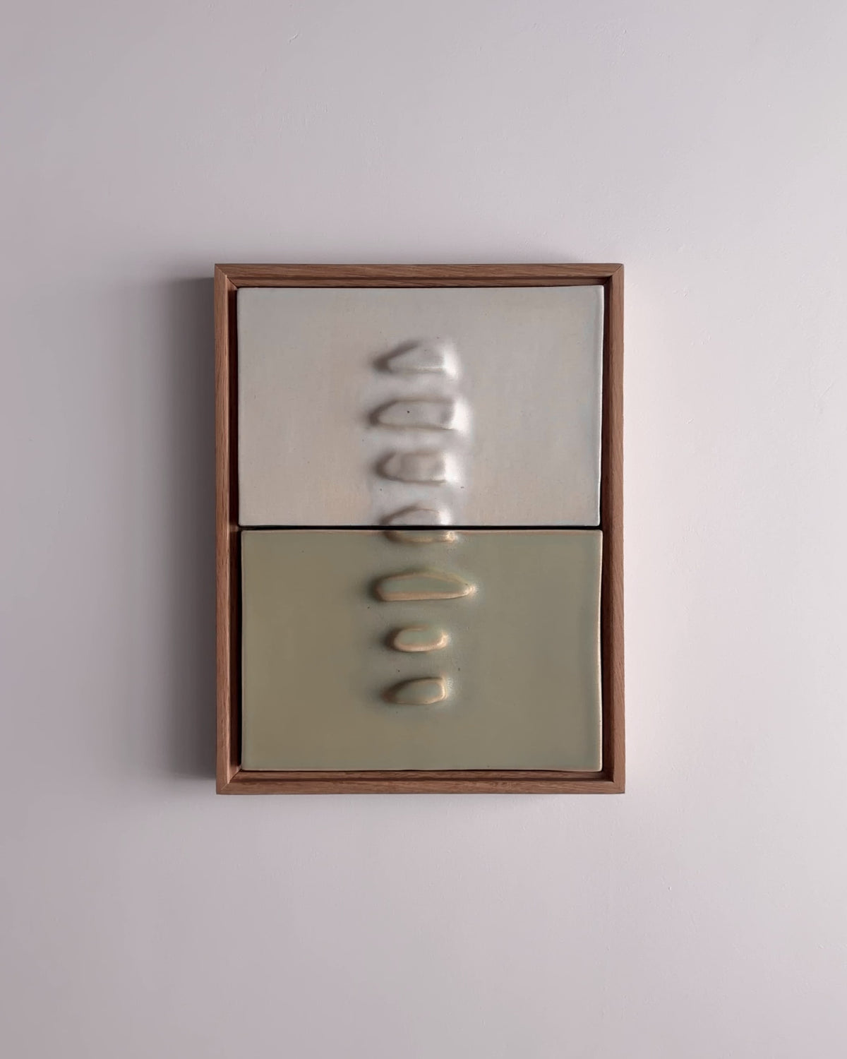 Video thumbnail of a framed two-panel ceramic wall relief in white and pale green