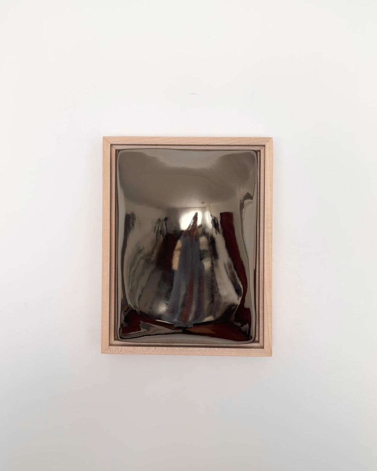 Video of Float 6x8" ceramic wall relief showing the rounded raised form and dark chrome glaze
