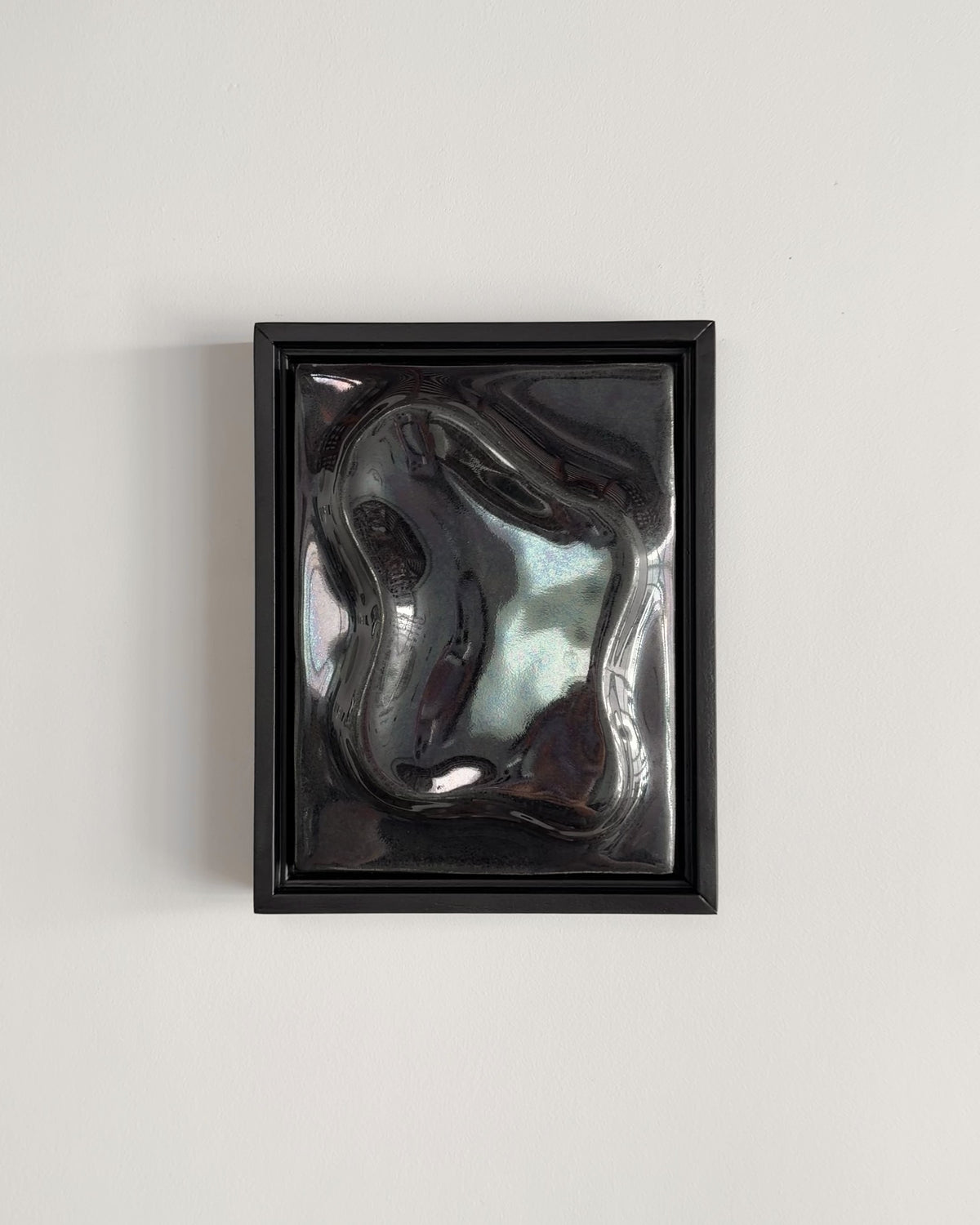Video thumbnail of a black framed reflective ceramic wall relief