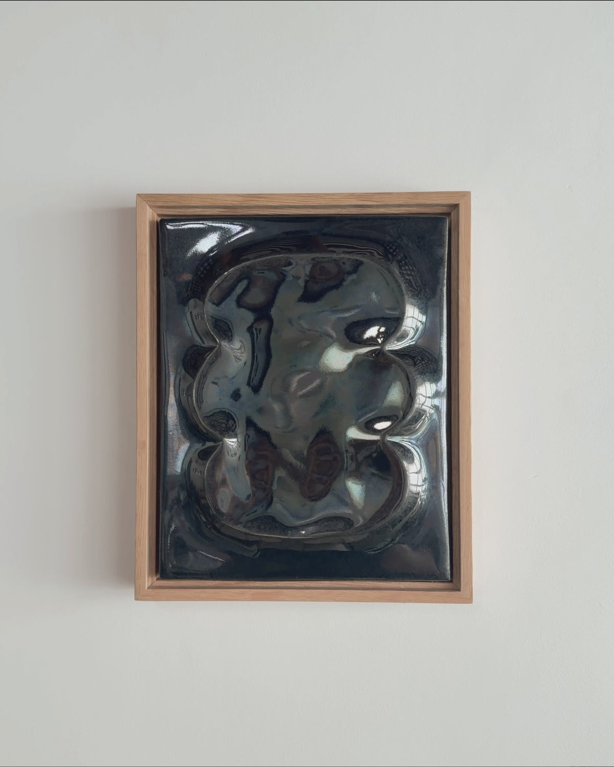 Video thumbnail of a black framed ceramic wall relief with raised organic forms